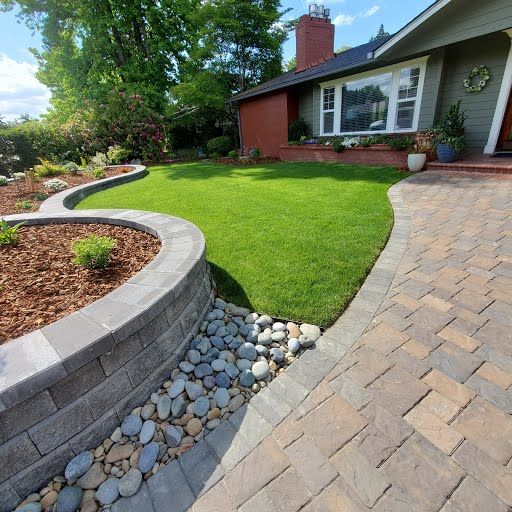 Paver driveway bordered by river rock landscaping, Ridgefield WA