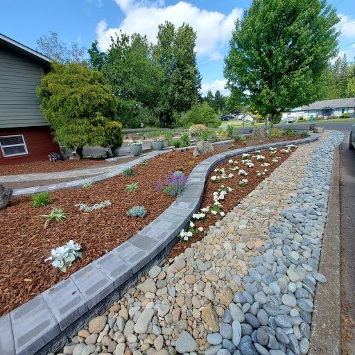 Landscape bed with river rock mulch and shrub plantings, Battle Ground WA