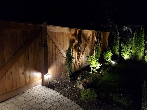 Garden gate with accent lighting and stone pillars, Clark County WA