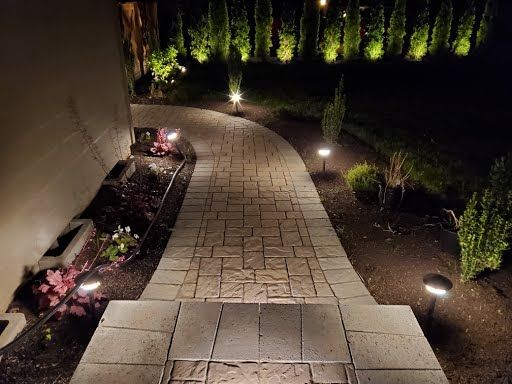 Curved paver walkway with warm uplighting at night, Battle Ground WA